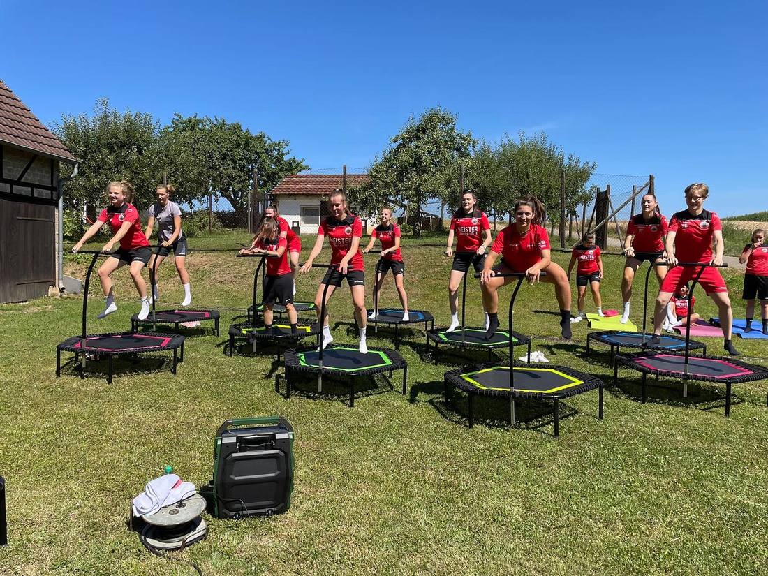 Die Fußballfrauen des TSV Plattenhardt springen in roten Trikots auf Trampolinen in Bojanas Garten